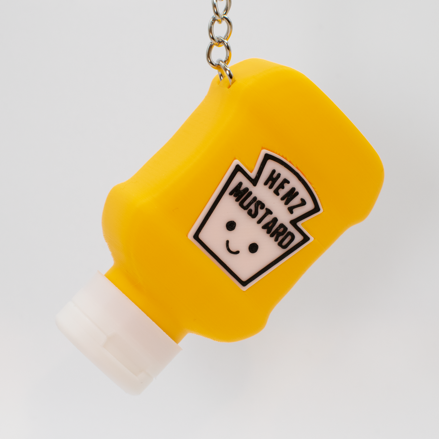 yellow mustard bottle fidget clicker keychains hanging as cute bag charms or key accessories