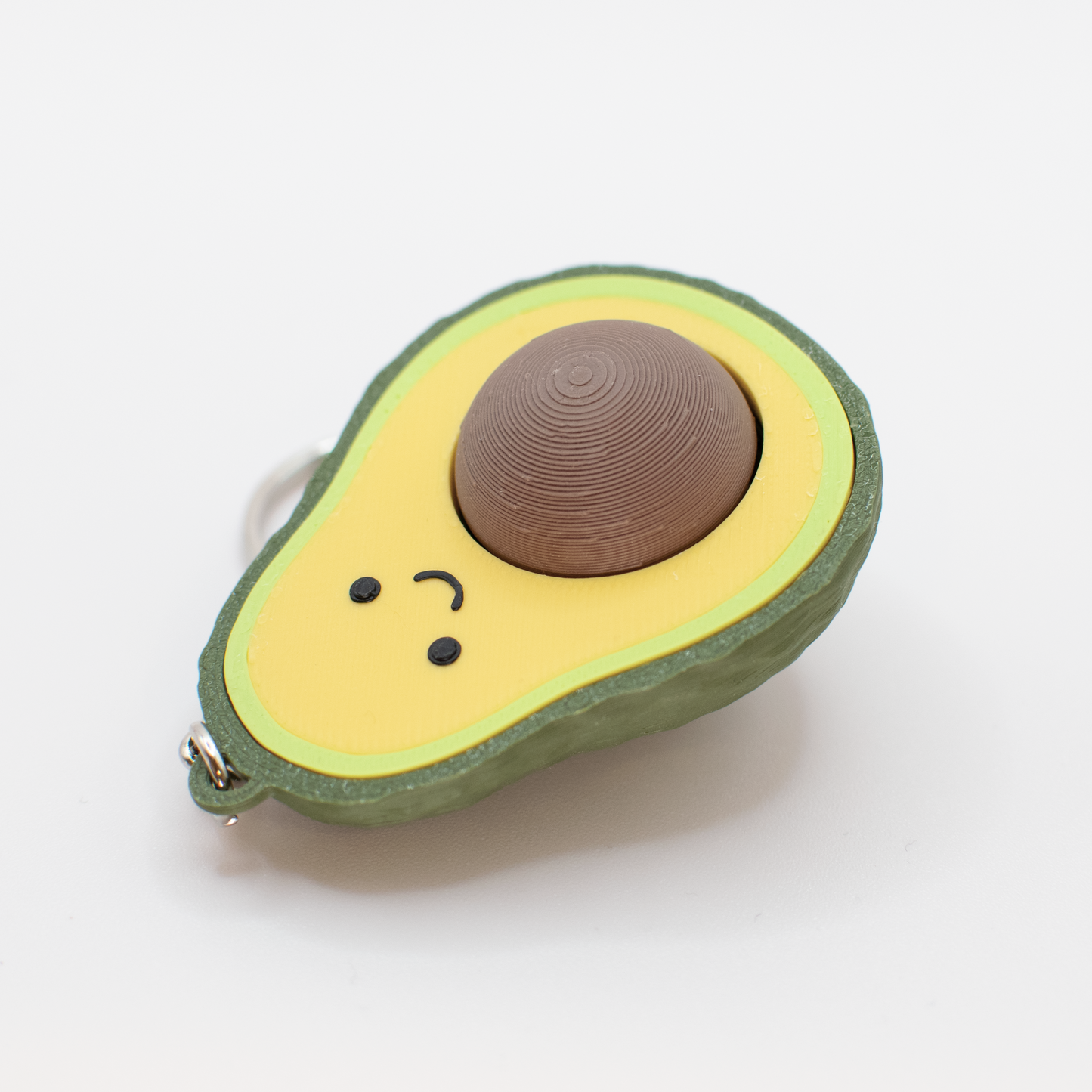 avocado fidget clicker keychain lay on desk
