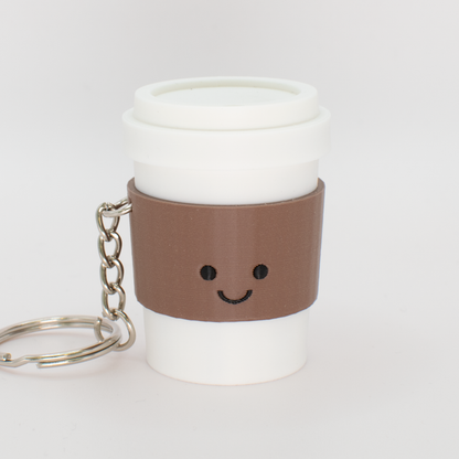 Cute coffee fidget clicker keychain with a mocha colored sleeve and smiling face