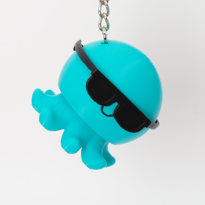 Turquoise octopus clicker keychain hanging as a fun bag charm or key accessory