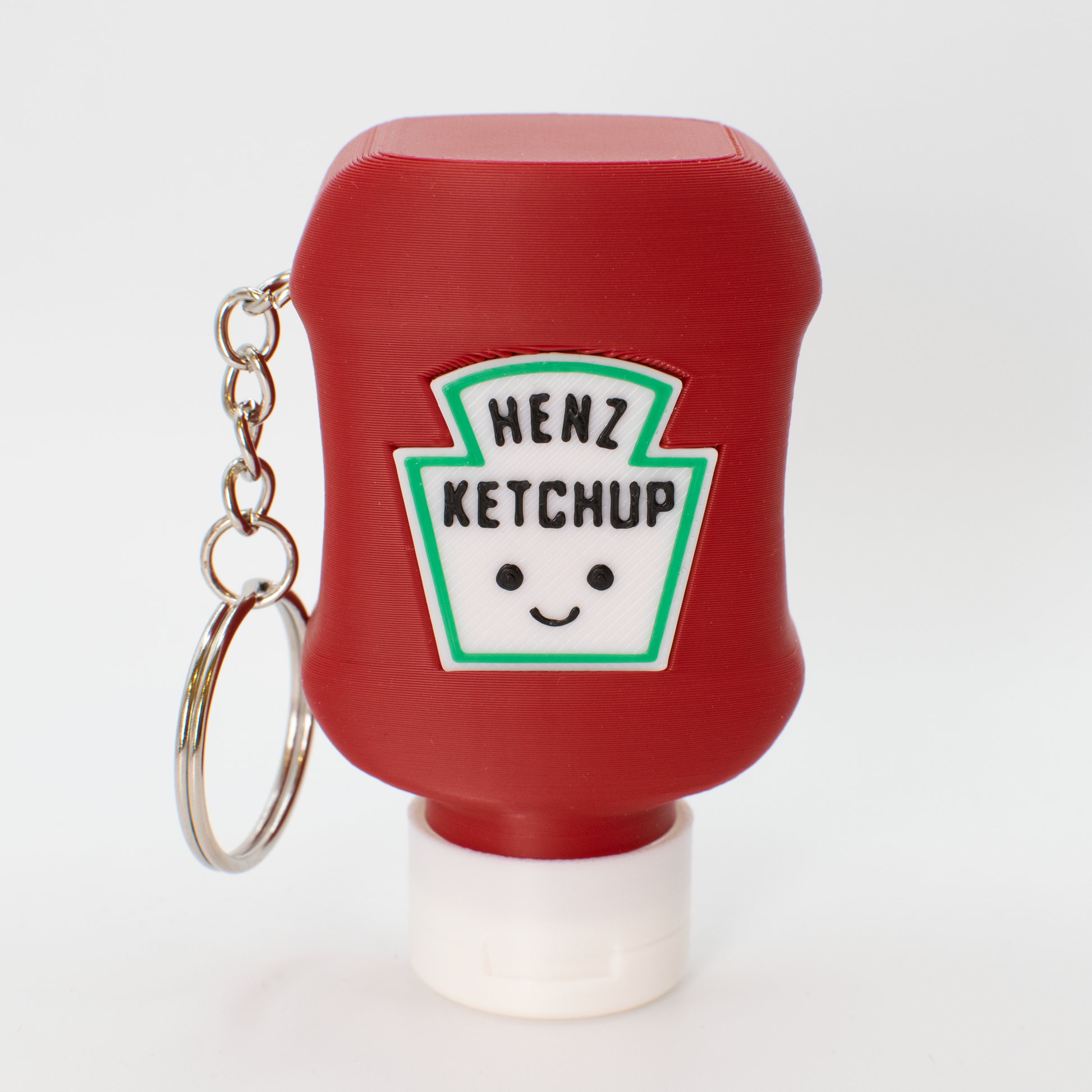 Red ketchup bottle fidget clicker keychain with a smiley face