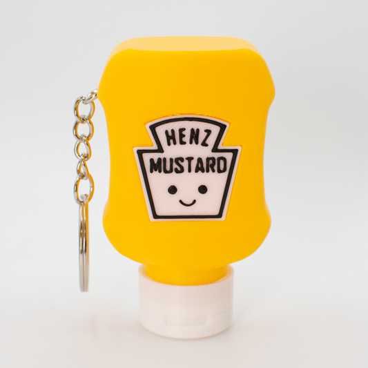 Yellow mustard bottle fidget clicker keychain with a smiley face label on a white background