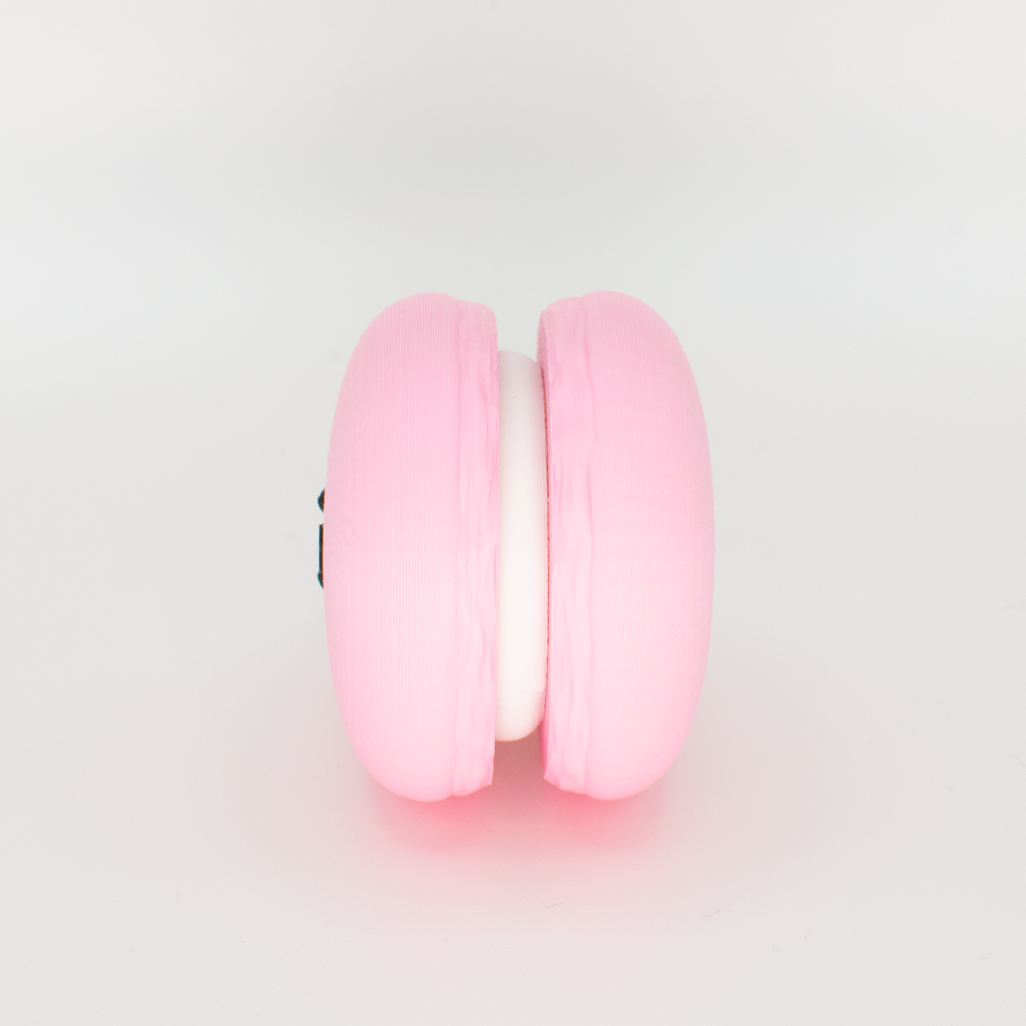Side view of an original macaron fidget clicker keychain showing the filling