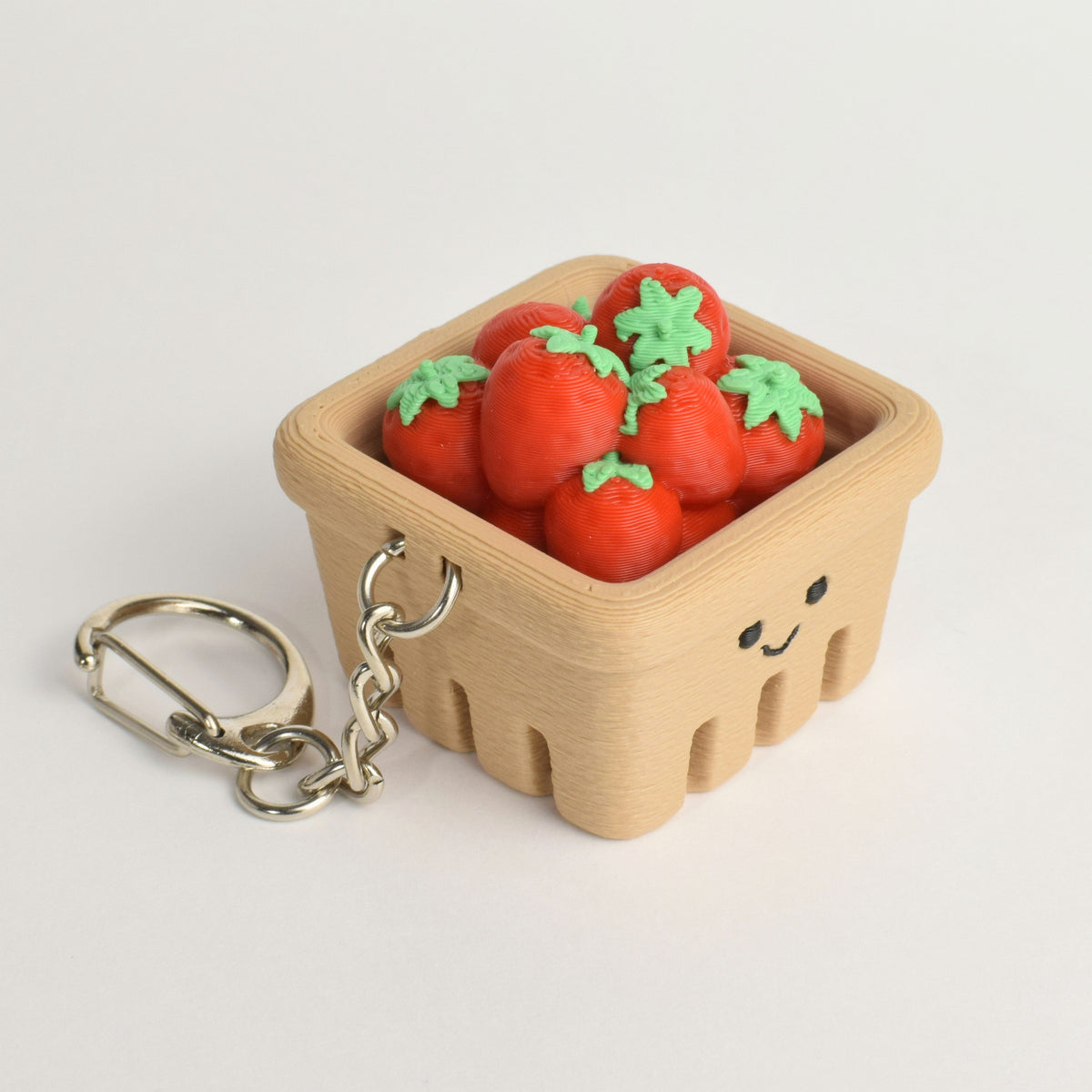 Side view of an original strawberry basket fidget clicker keychain
