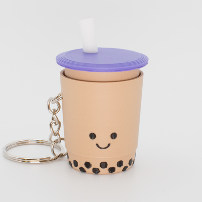 Cute bubble tea fidget clicker keychain with black boba pearls and a smiling face and a purple lid