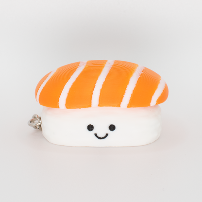 Cute salmon sushi fidget clicker keychain with an adorable smiling face