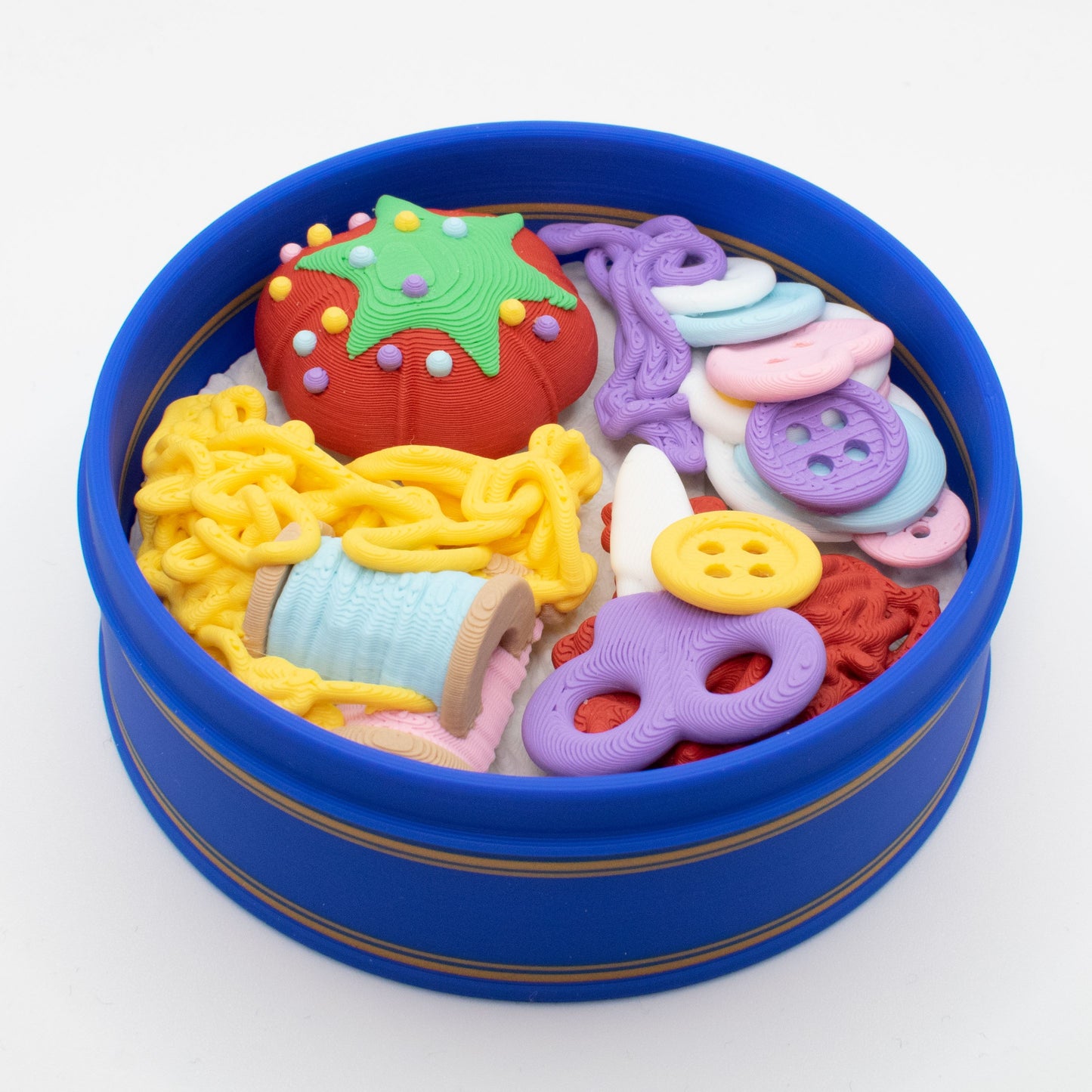 fidget clicker designed as colorful sewing supplies in a nostalgic blue tin 