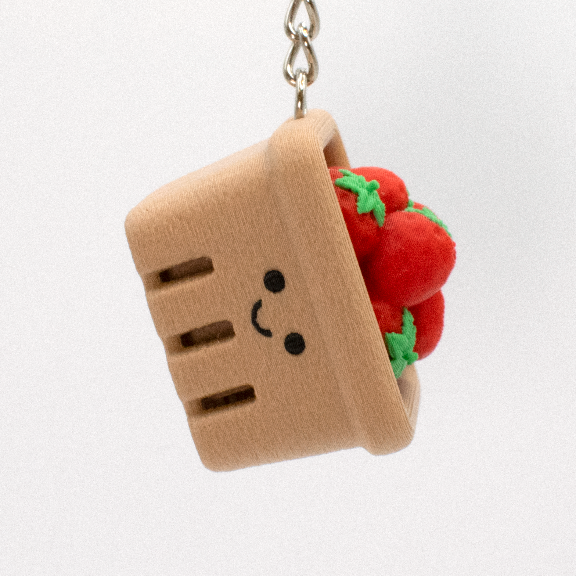 Strawberry basket fidget clicker keychain hanging as a cute bag charm or key accessory