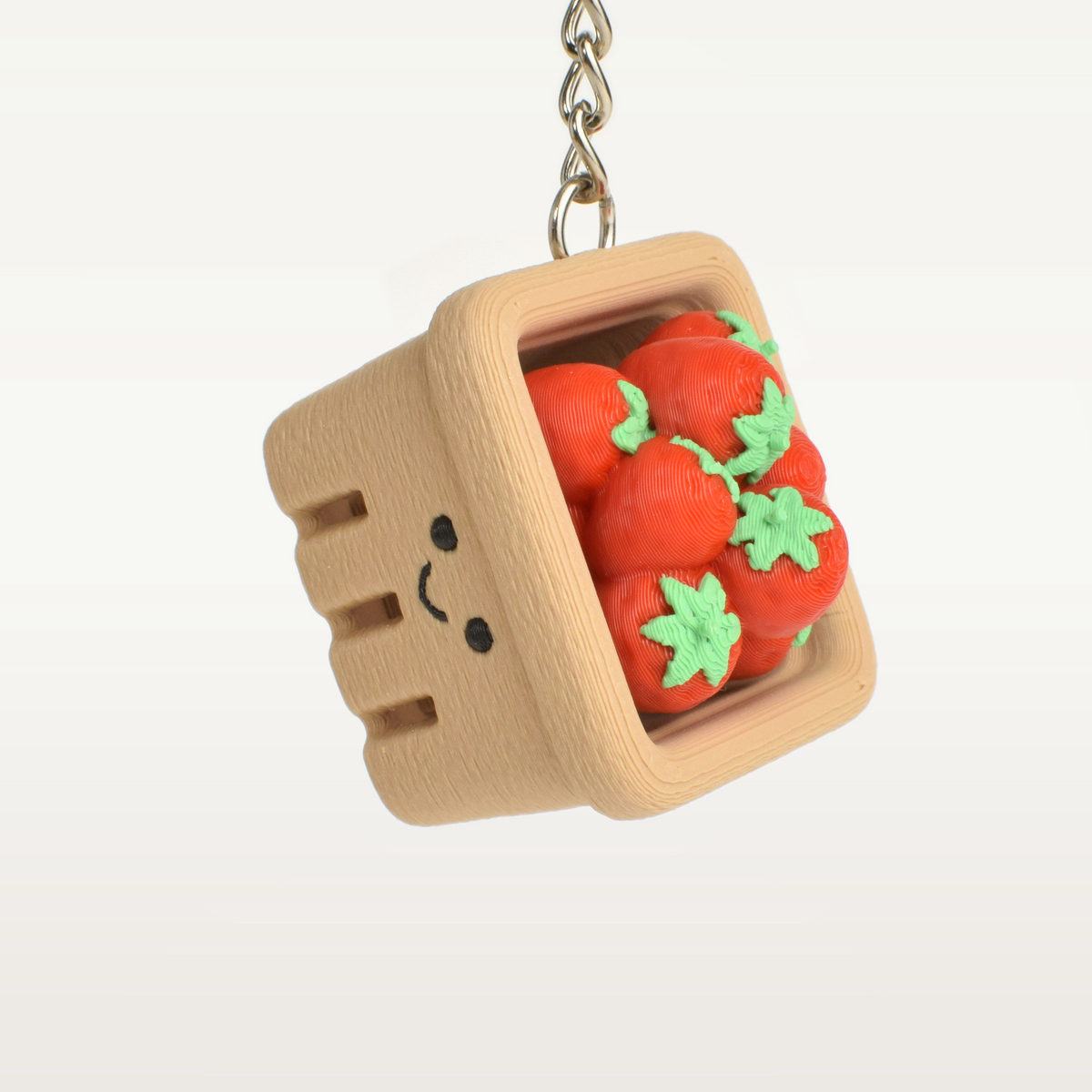 Strawberry basket fidget clicker keychain hanging as a cute bag charm or key accessory