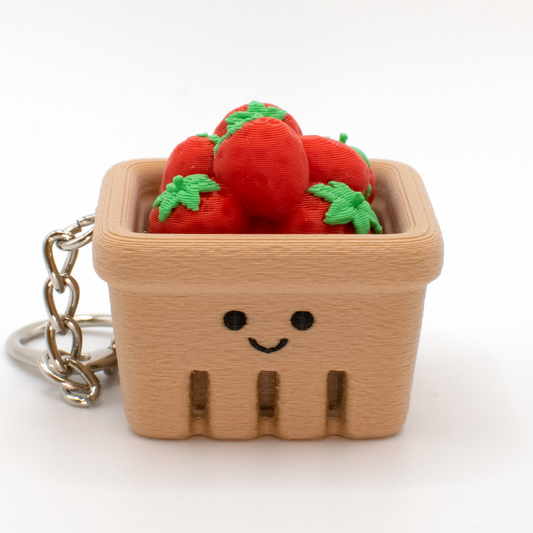 Cute strawberry basket fidget clicker keychain with tiny strawberries and a smiling face