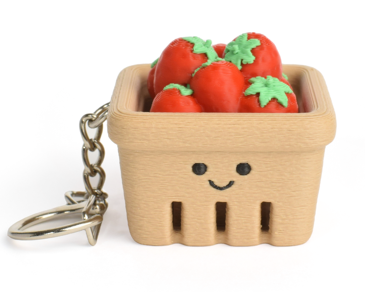 Cute strawberry basket fidget clicker keychain with tiny strawberries and a smiling face