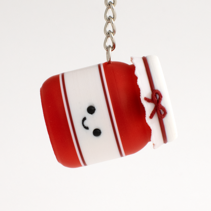 Strawberry jam fidget clicker keychain hanging as a cute bag charm or key accessory