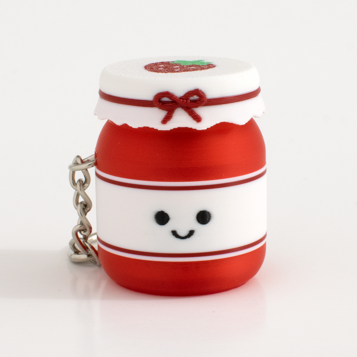 Cute strawberry jam fidget clicker keychain with a smiling face and tiny jar design