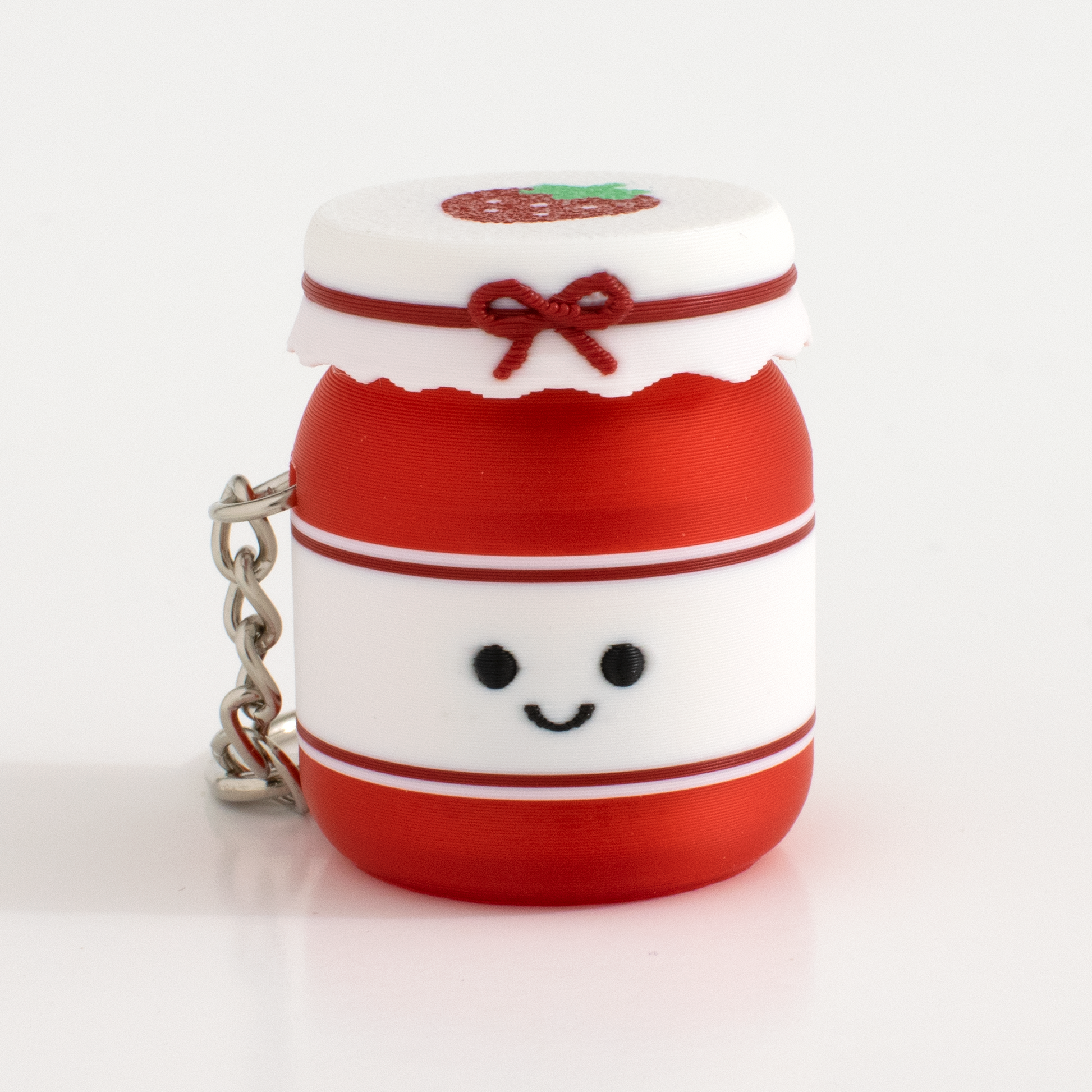 Cute strawberry jam fidget clicker keychain with a smiling face and tiny jar design