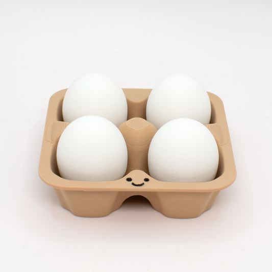 fidget clicker styled as a beige egg carton with four white eggs inside,  with a smiling face on the carton.