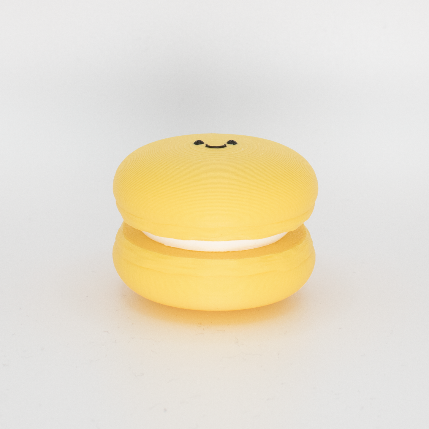 Side view of an original yellow macaron fidget clicker keychain