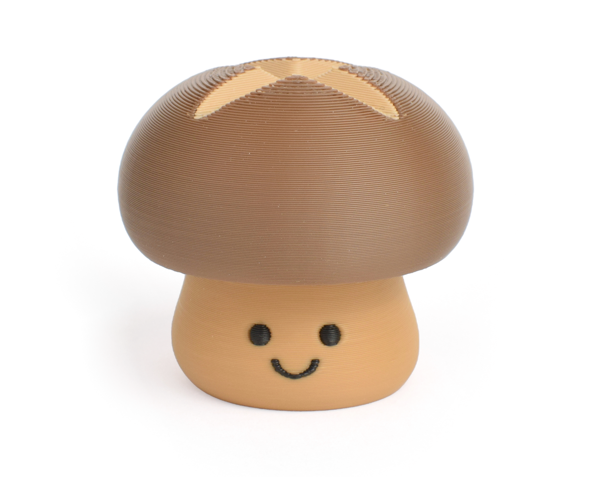 Cute brown shiitake mushroom fidget clicker with a chubby cap and white dots and smiling face