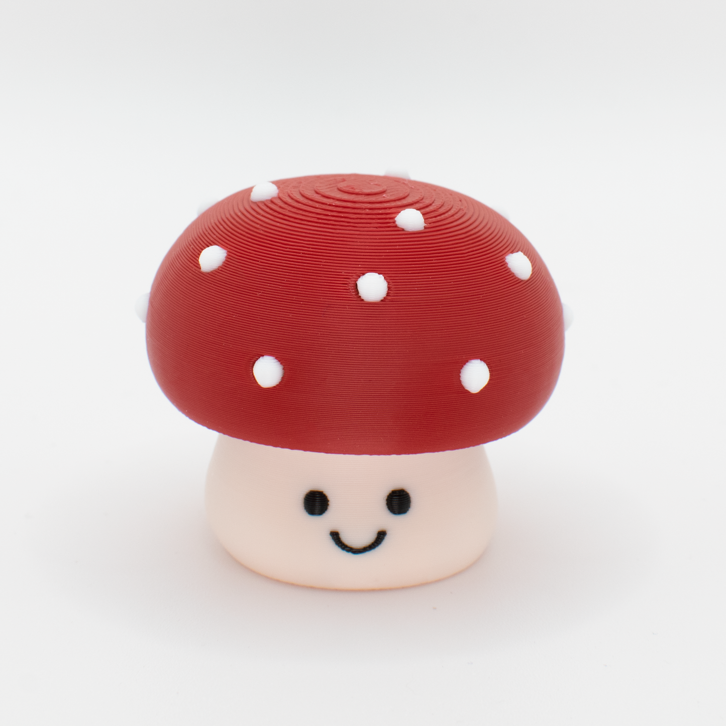 Cute toxic mushroom fidget clicker with a chubby cap and white dots and smiling face