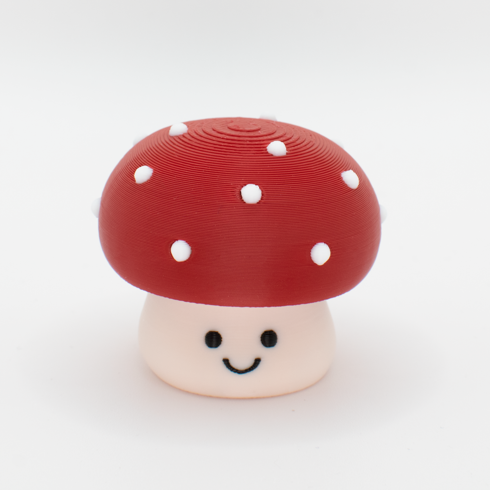 Cute toxic mushroom fidget clicker with a chubby cap and white dots and smiling face
