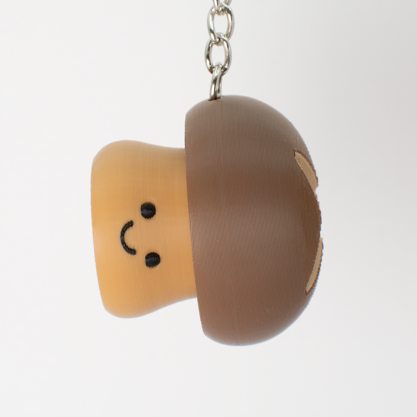Cute mushroom clicker keychain hanging as a fun bag or key accessory