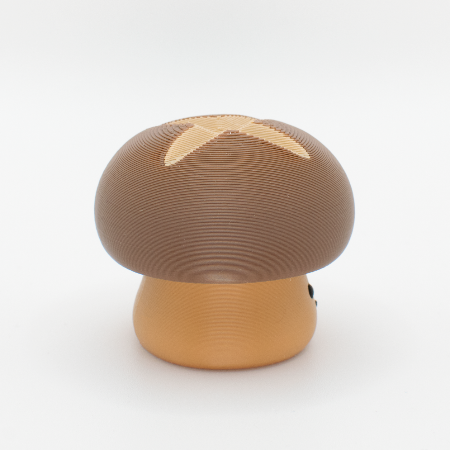 Side view of a chubby mushroom mechanical switch fidget toy