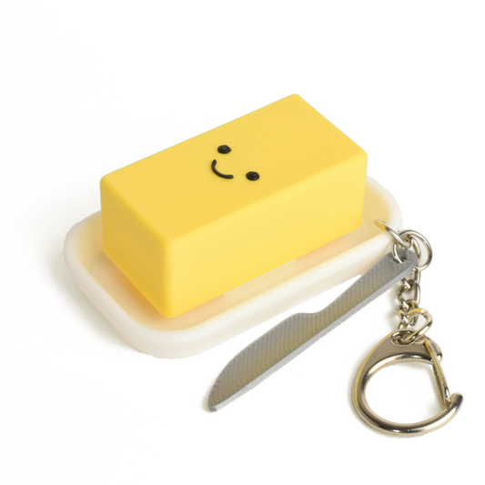 Cute creamy butter fidget clicker keychain with a smiling face