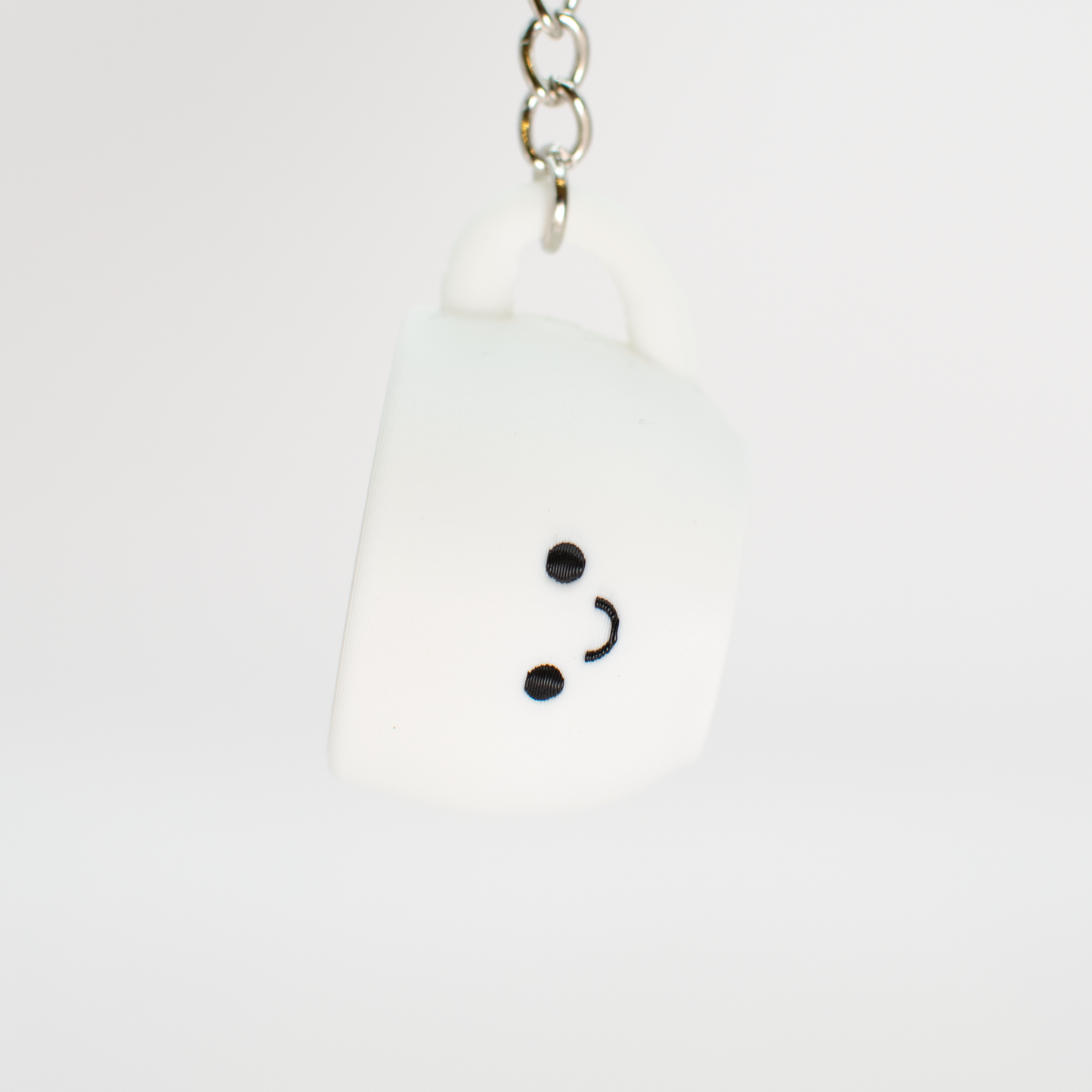 cute coffee clicker being hung on a keychain