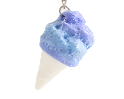 A cotton candy shaped fidget clicker, featuring a textured blue and purple swirled top and a white cone base, suspended from a silver metal chain against a plain white background.