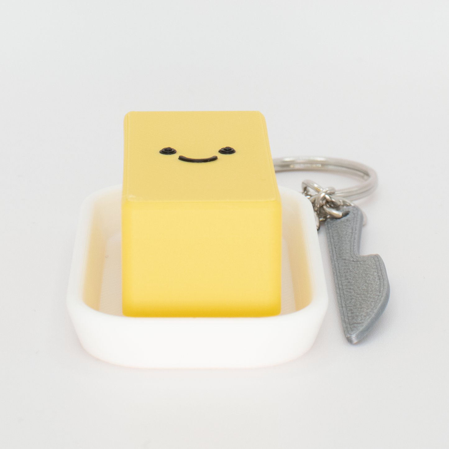 an original creamy butter fidget clicker keychain lay on a table