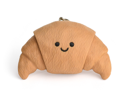 a cute croissant clicker keychain with smiley face, with two clickable ends