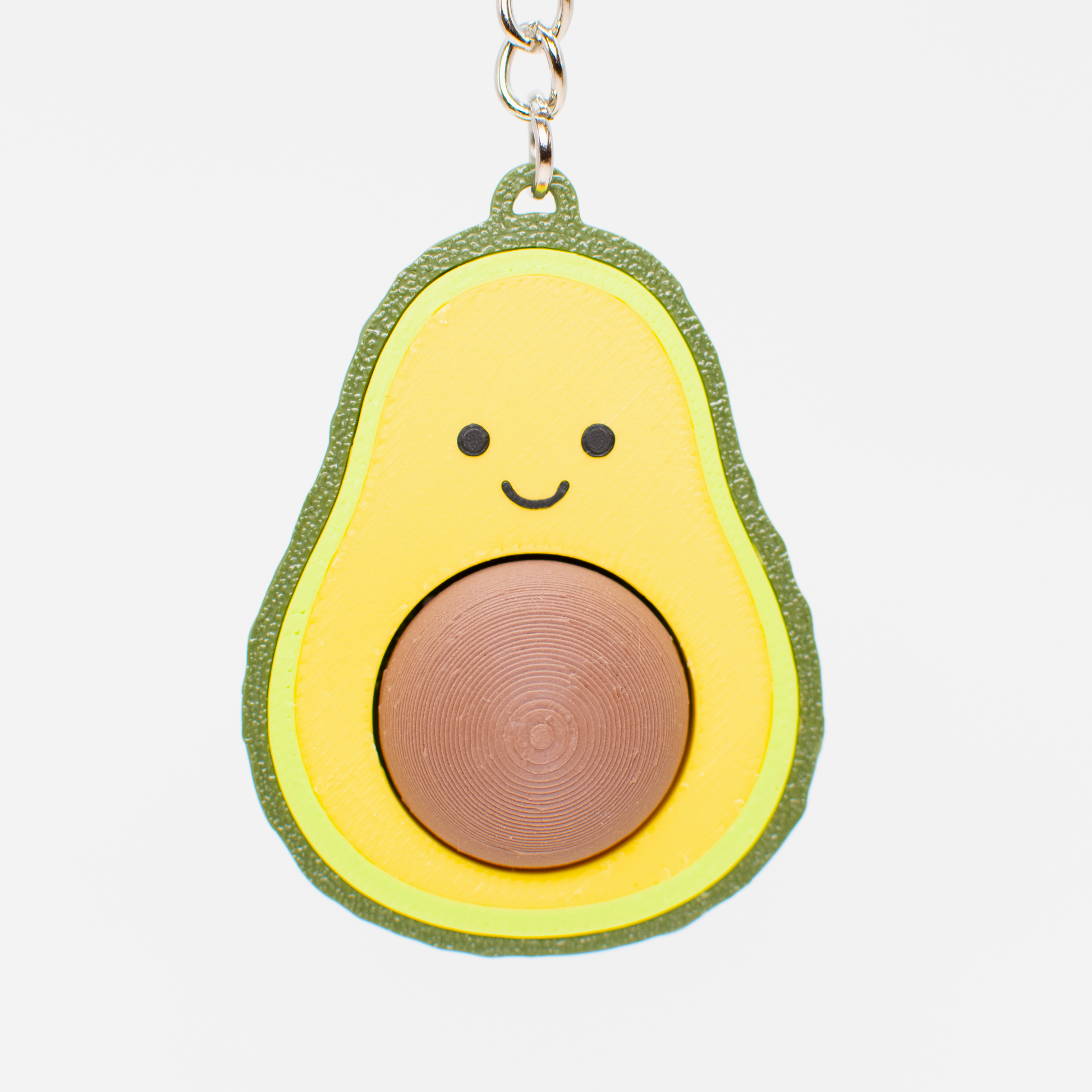 Avocado fidget toy keychain with a smiling face 