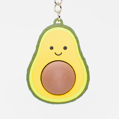 Avocado fidget toy keychain with a smiling face 