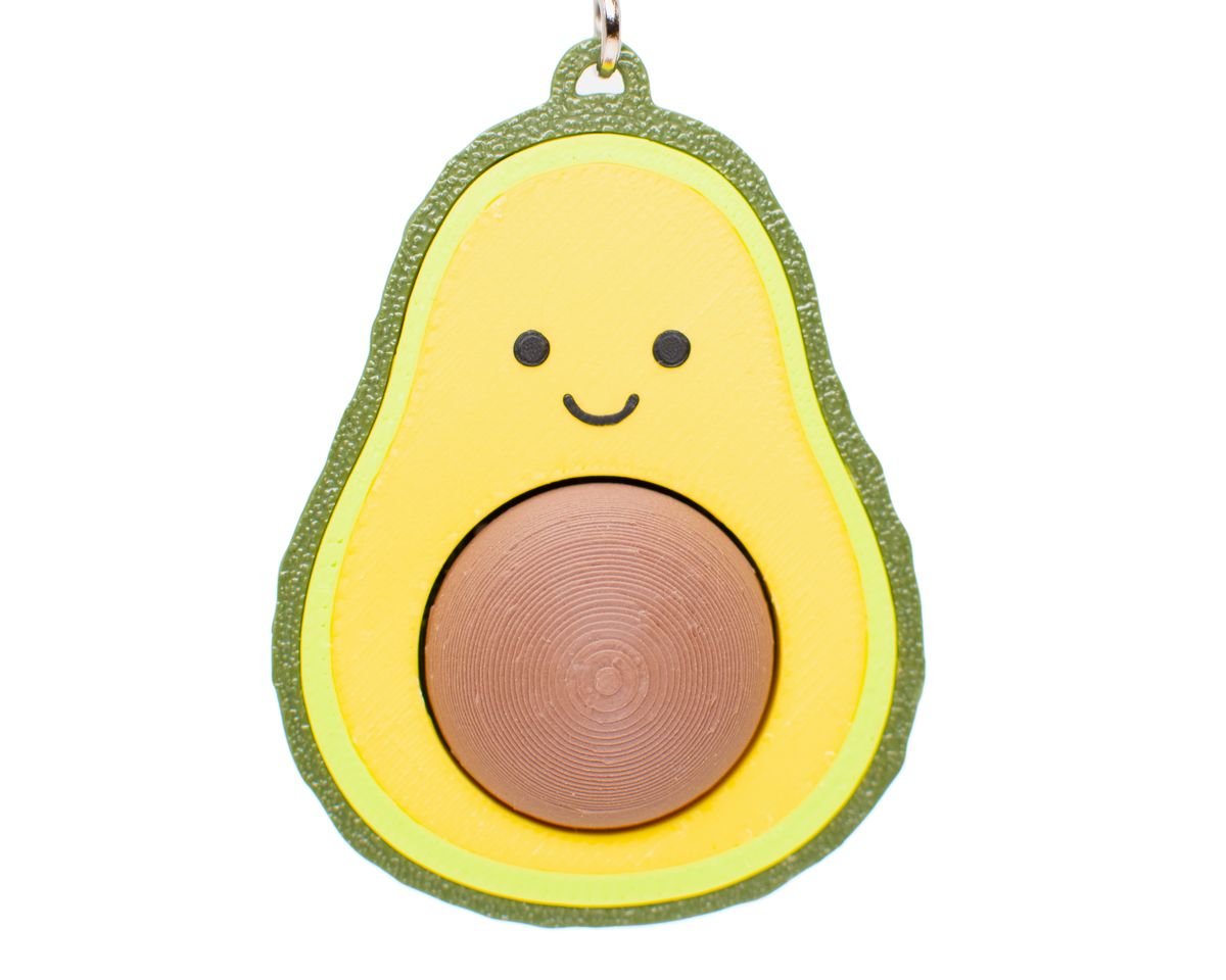 Avocado fidget toy keychain with a smiling face