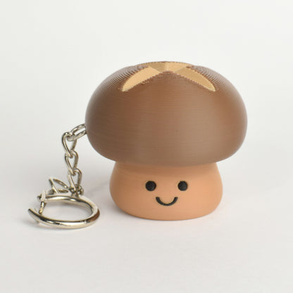 Cute brown mushroom clicker keychain with a smiling face