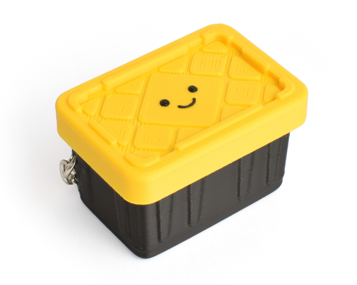 a cute yellow and black container fidget clicker with a smiley face