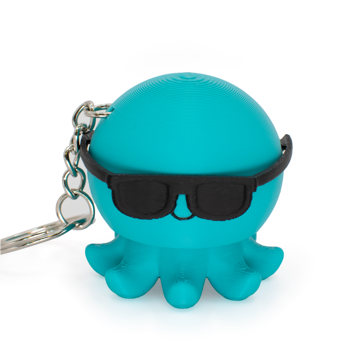 Turquoise octopus fidget clicker keychain with black sunglasses on a light gray background