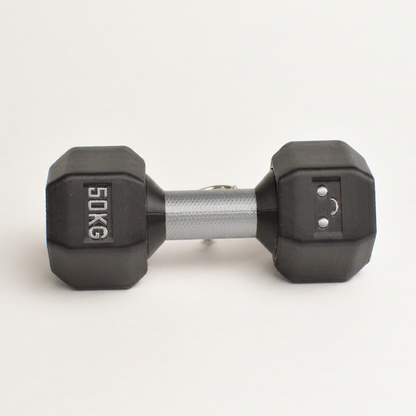 A "50 kg" hexagonal dumbbell clicker with black rubberized looking ends and a textured silver metal handle, shown on a clean white background.