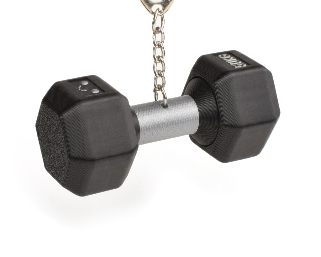 A miniature black dumbbell-shaped fidget clicker keychain with a silver metal handle and a silver split ring on a white background.