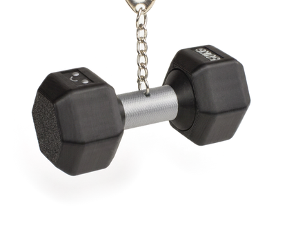 A miniature black dumbbell-shaped fidget clicker keychain with a silver metal handle and a silver split ring on a white background.