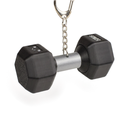 A miniature black dumbbell-shaped fidget clicker keychain with a silver metal handle and a silver split ring on a white background.