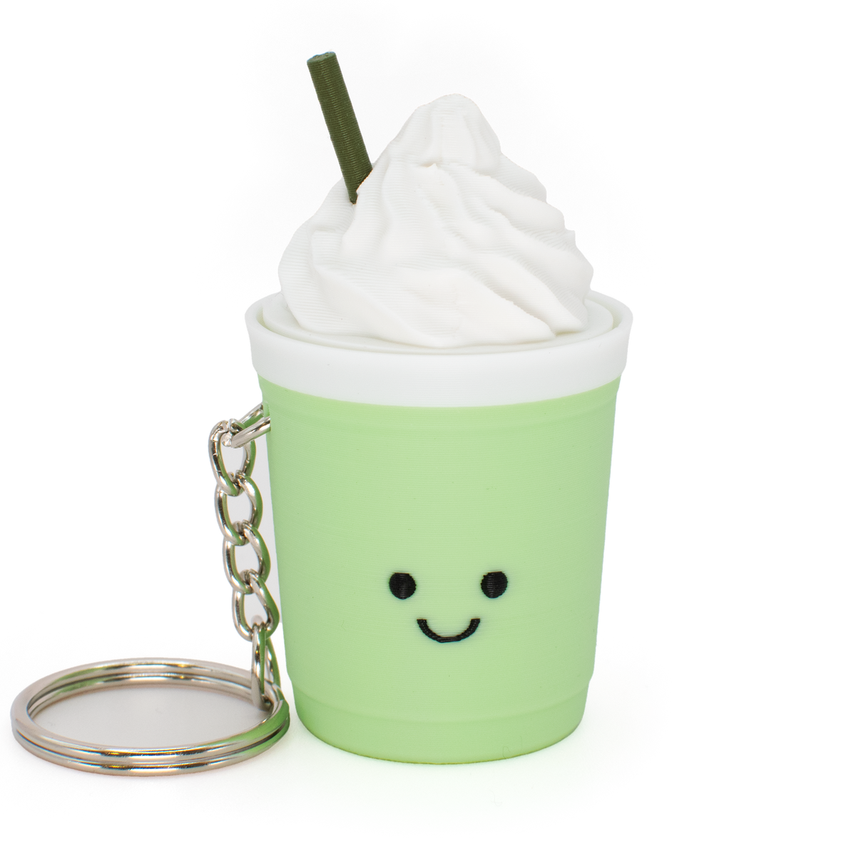 A cute, kawaii-style clicker keychain shaped like a light green iced coffee cup with whipped cream and a straw, featuring a smiling face and a silver keyring.
