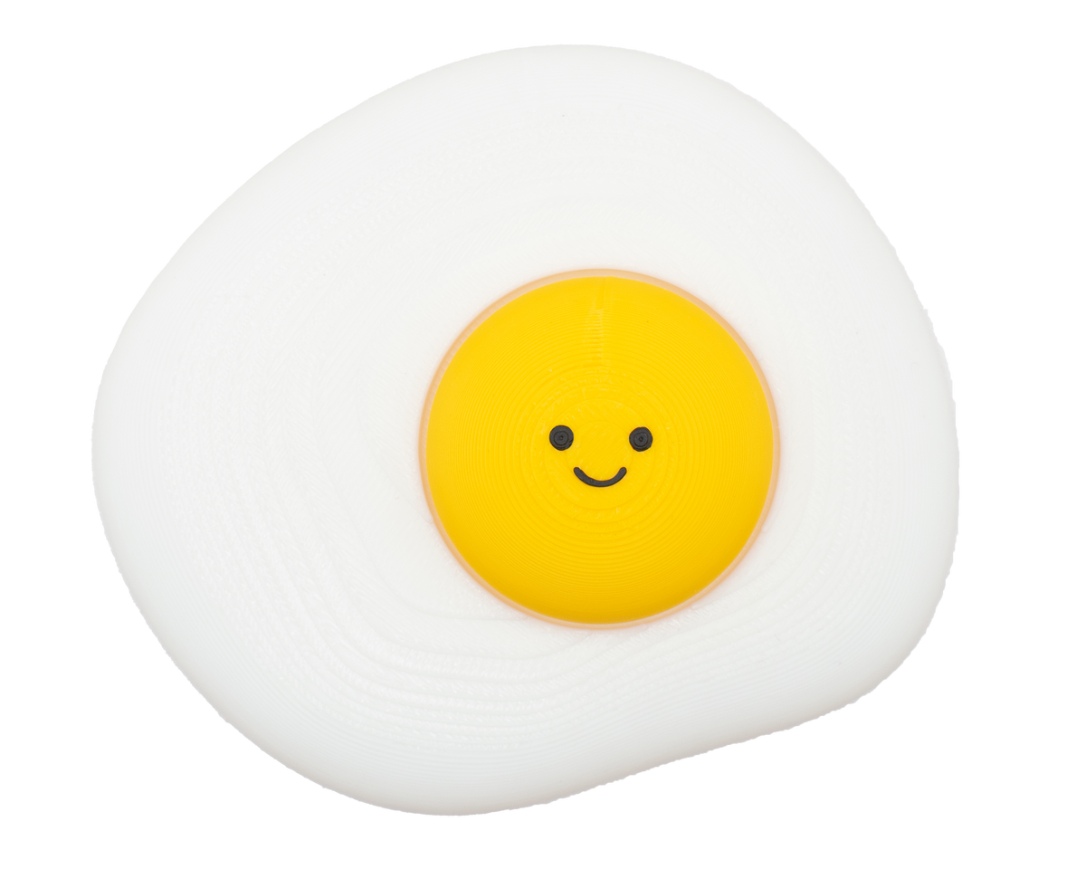 Cute fried egg fidget clicker desk buddy with a cheerful smile and clicky yolk