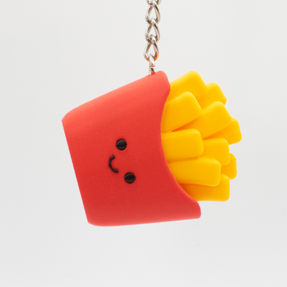 cute fast food French fries fidget clicker with a smiling face being hung on a keychain