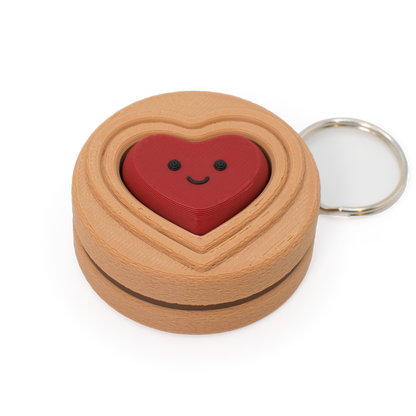cookie with chocolate color filling clicker keychain with a red heart inside on a white background