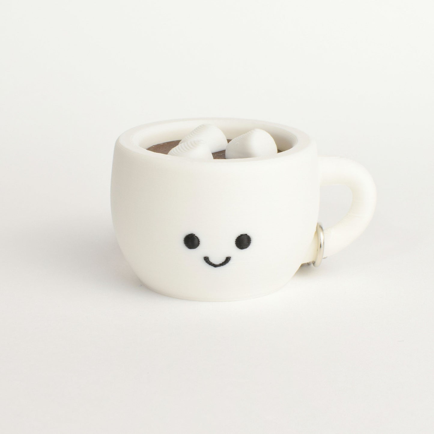 fidget clicker styled as a hot chocolate with marshmallows in a white mug with a smiley face on a white background