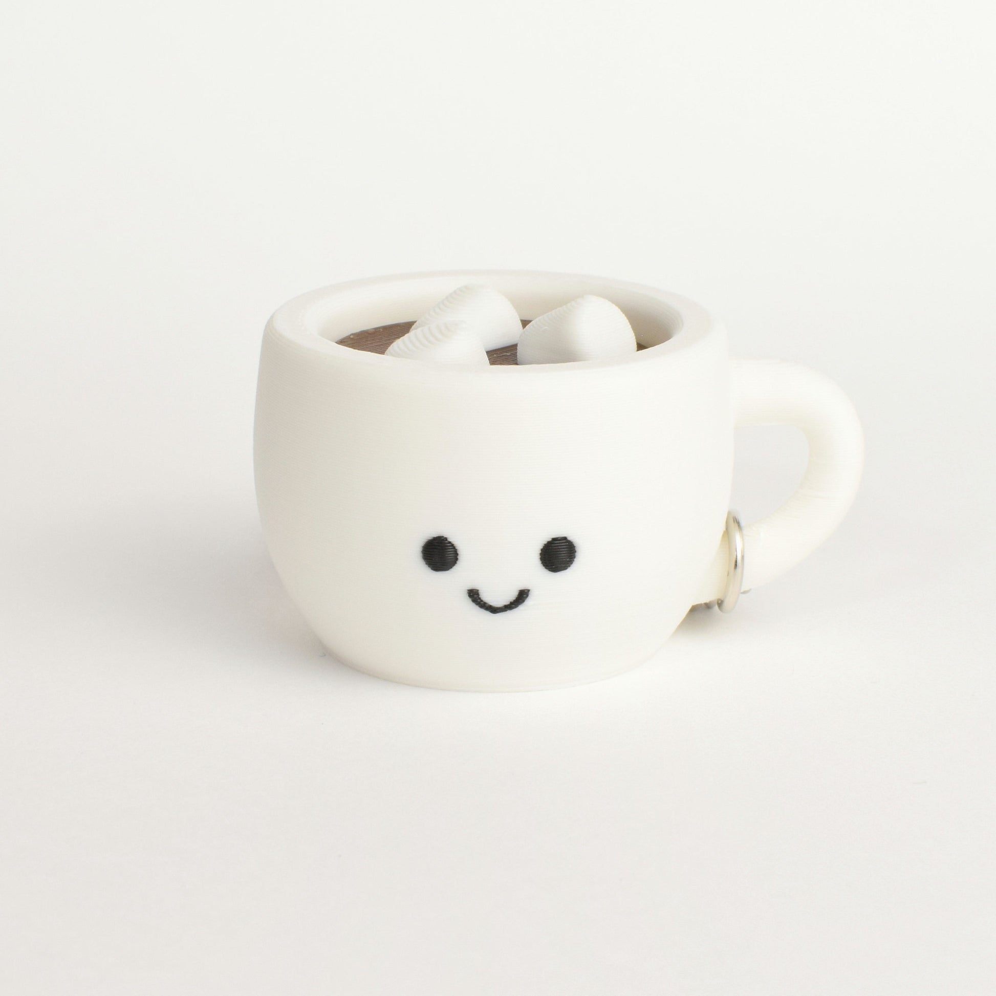 fidget clicker styled as a hot chocolate with marshmallows in a white mug with a smiley face on a white background
