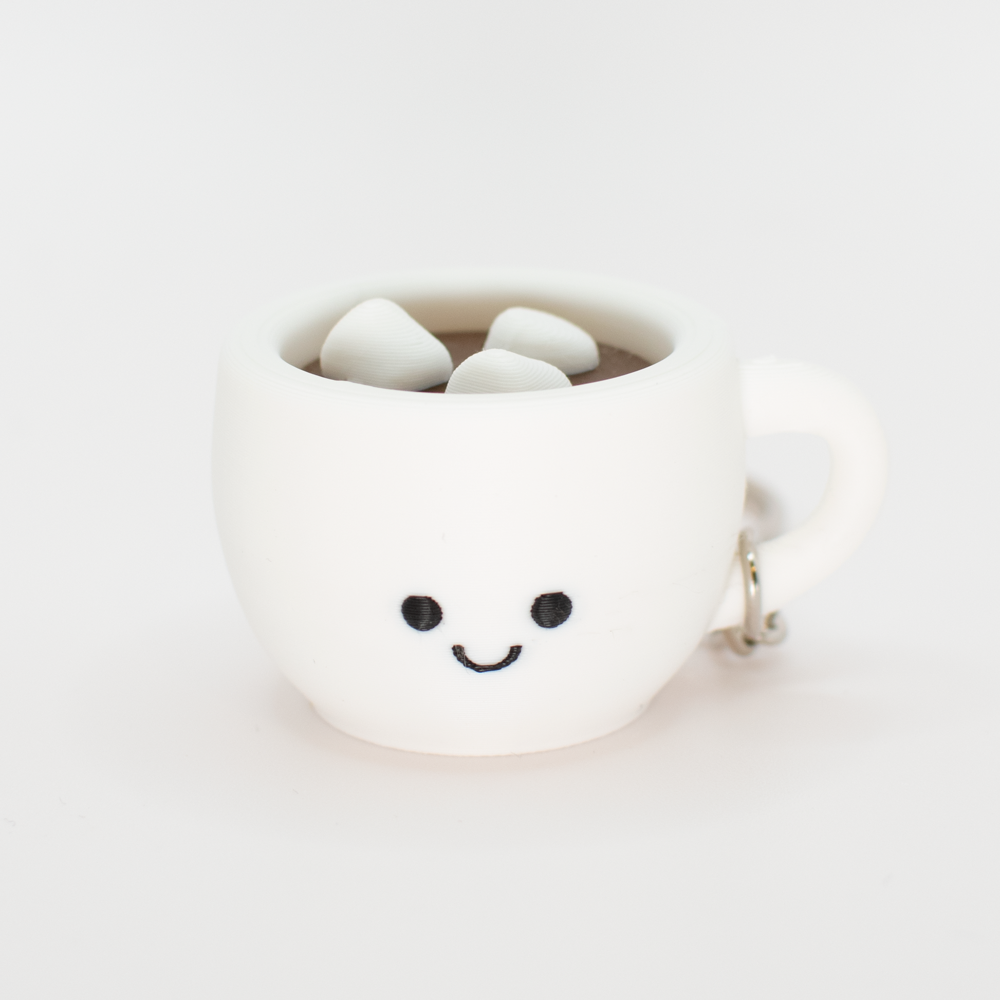 fidget clicker styled as a hot chocolate with marshmallows in a white mug with a smiley face on a white background