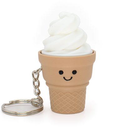 An ice cream cone clicker keychain with a smiling face, featuring white soft-serve swirl details and a waffle-cone base, attached to a silver metal keyring on a white background.