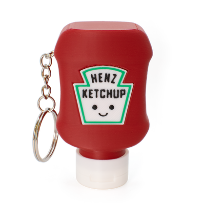 Red ketchup bottle fidget clicker keychain with a smiley face