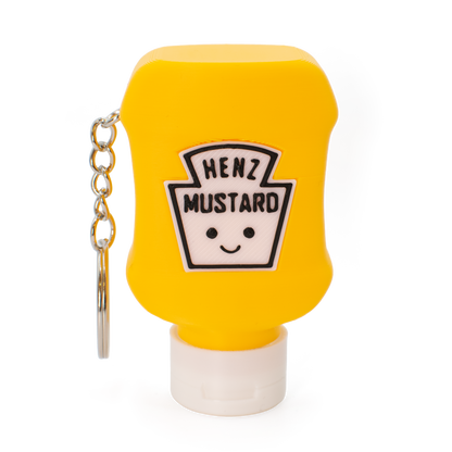 Yellow mustard bottle fidget clicker keychain with a smiley face label on a white background